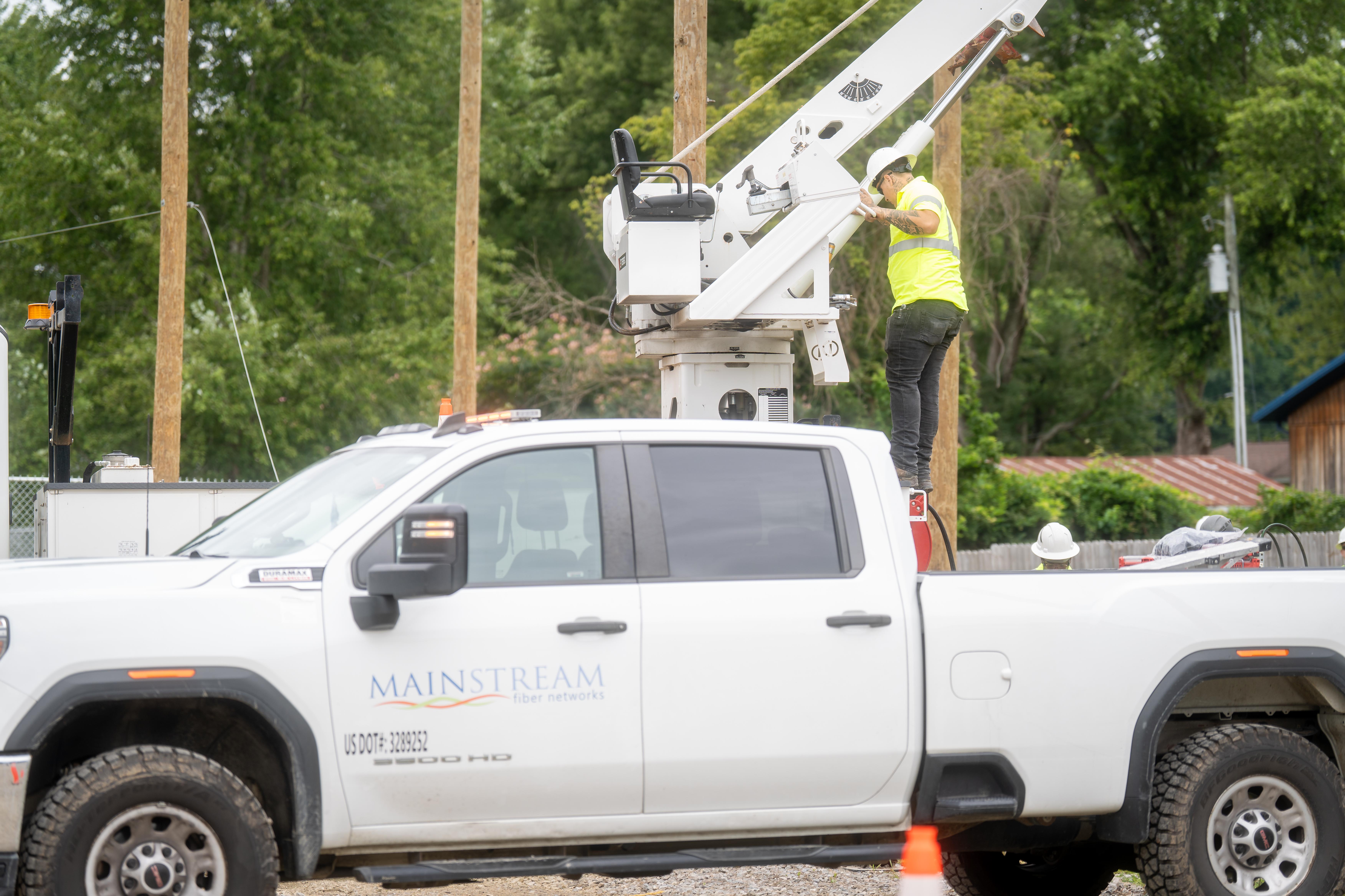 Fiber internet technician servicing residential broadband equipment, representing flexible no-contract internet options.